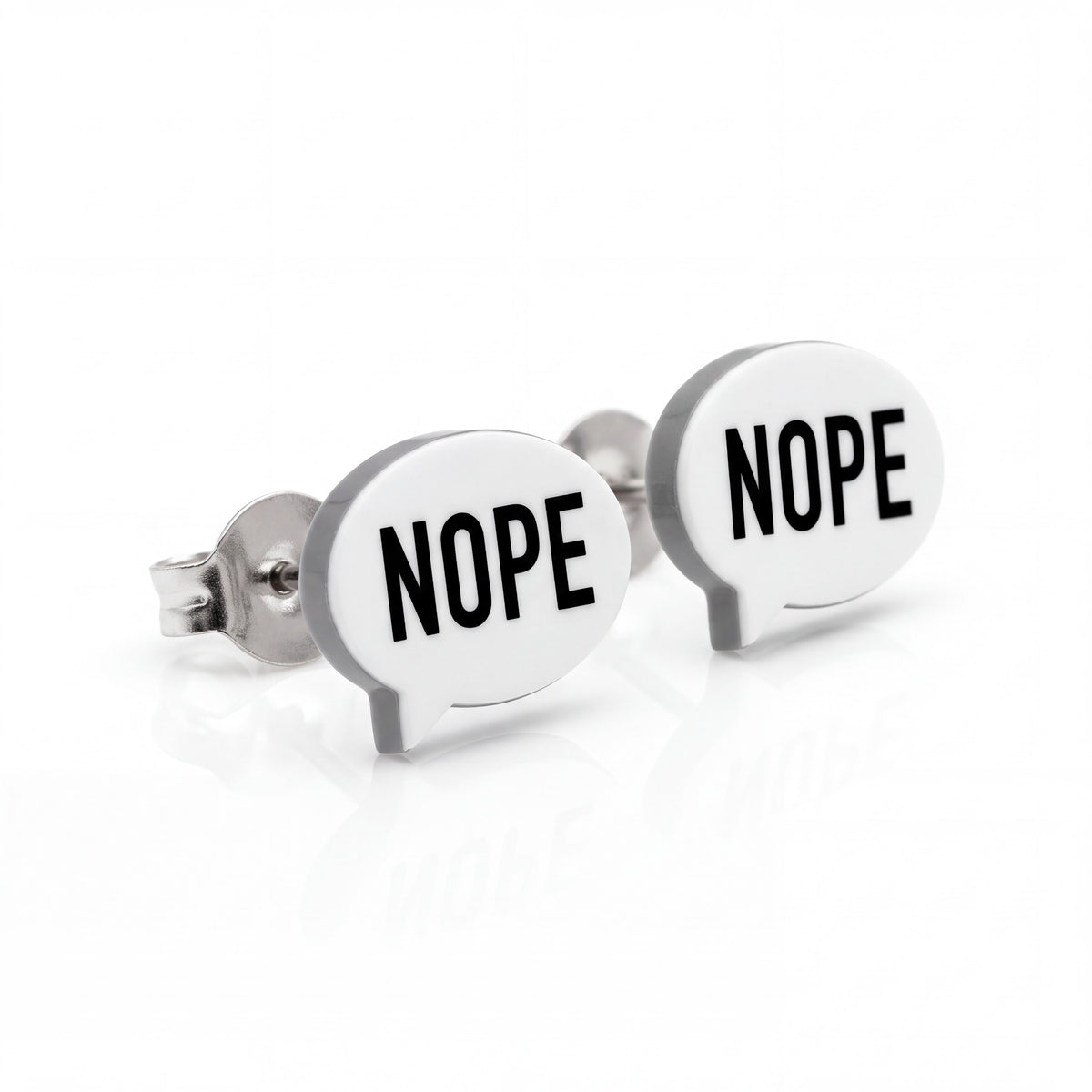 Doodlations Coffee Bar & Boutique Nope stud earrings featuring white speech bubbles with black text and steel posts.