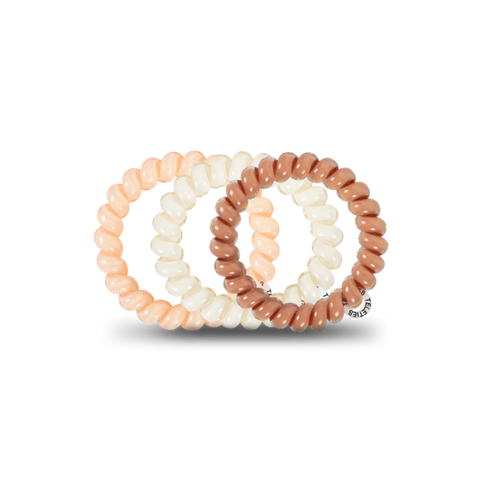 Doodlations Coffee Bar & Boutique For the Love of Nudes spiral hair ties in assorted beige and brown shades.