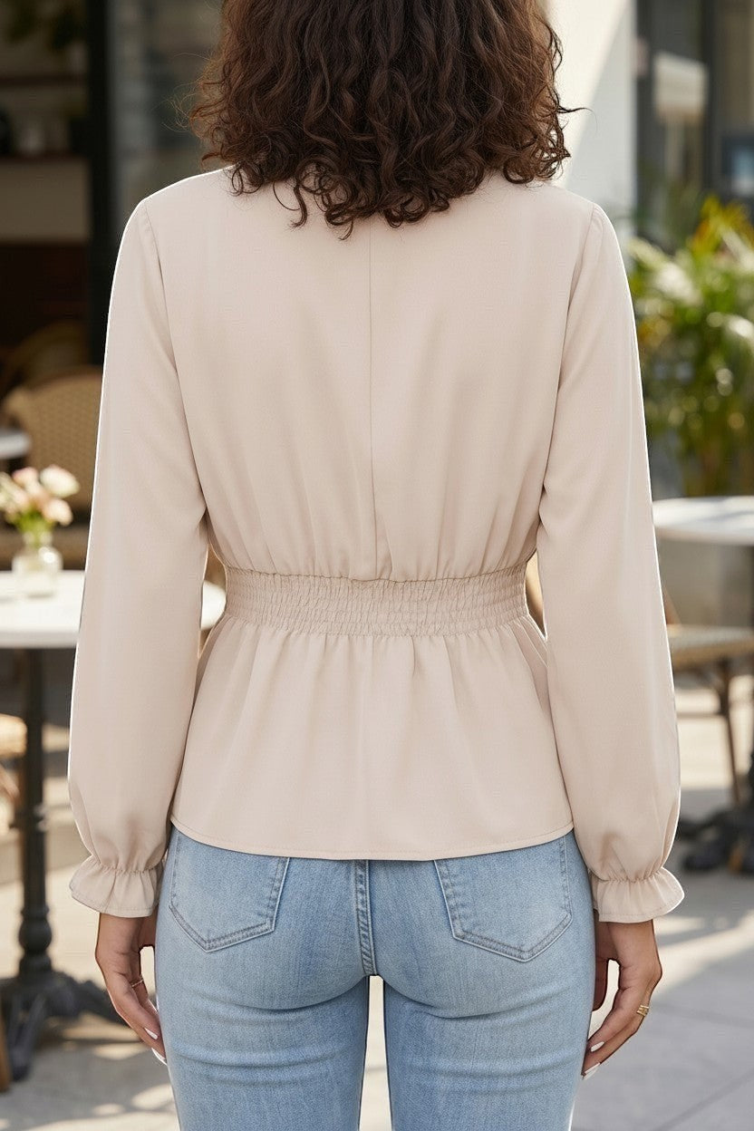 Back view of Doodlations Coffee Bar & Boutique oatmeal long sleeve blouse with cinched elastic waist and ruffled cuffs