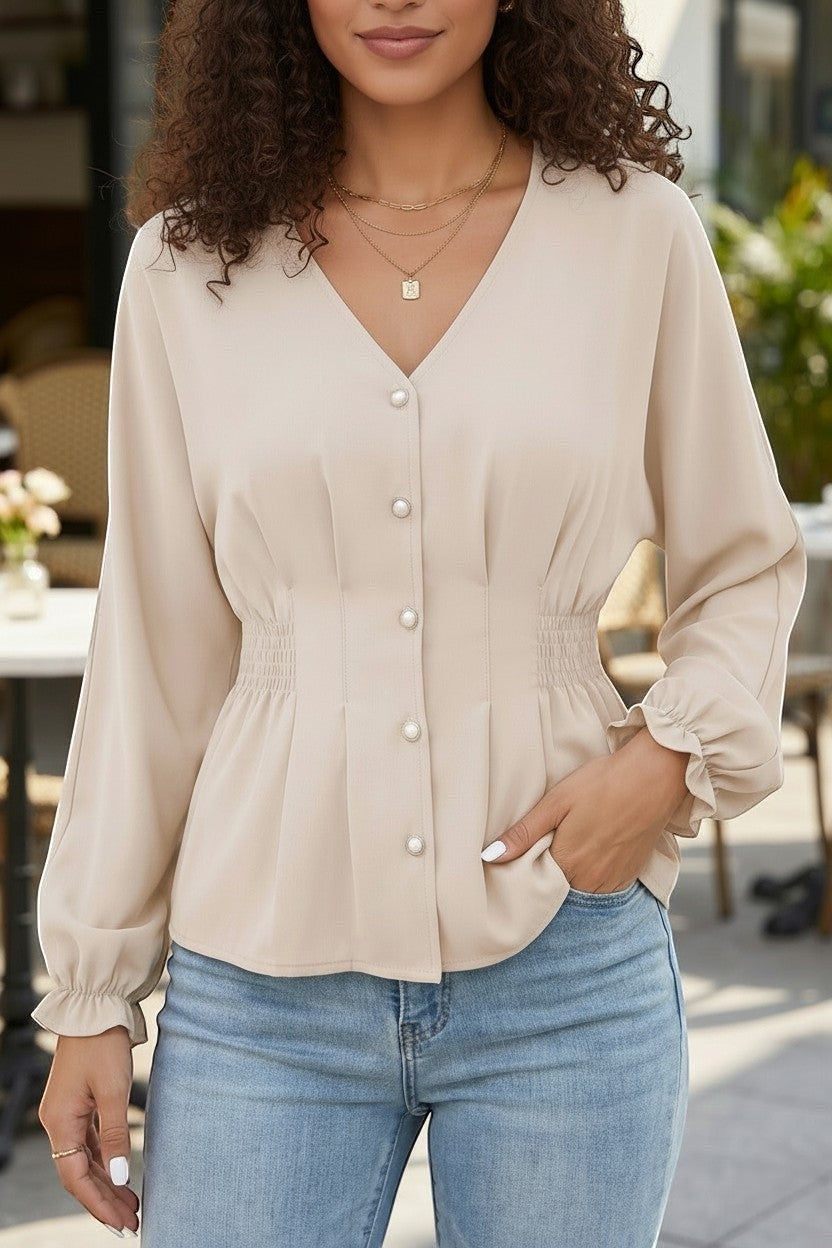 Doodlations Coffee Bar & Boutique oatmeal V-neck blouse with pearl buttons, cinched waist, and ruffled long sleeves.