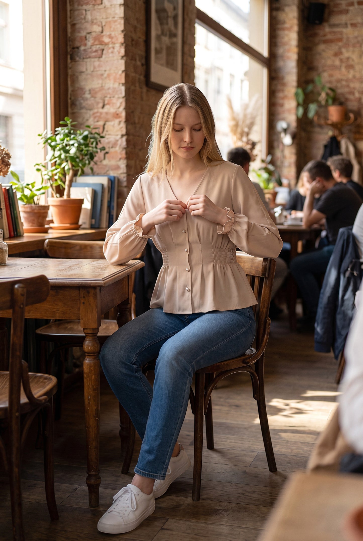 Doodlations Coffee Bar & Boutique oatmeal V-neck blouse with pearl buttons and ruffled cuffs worn with blue jeans