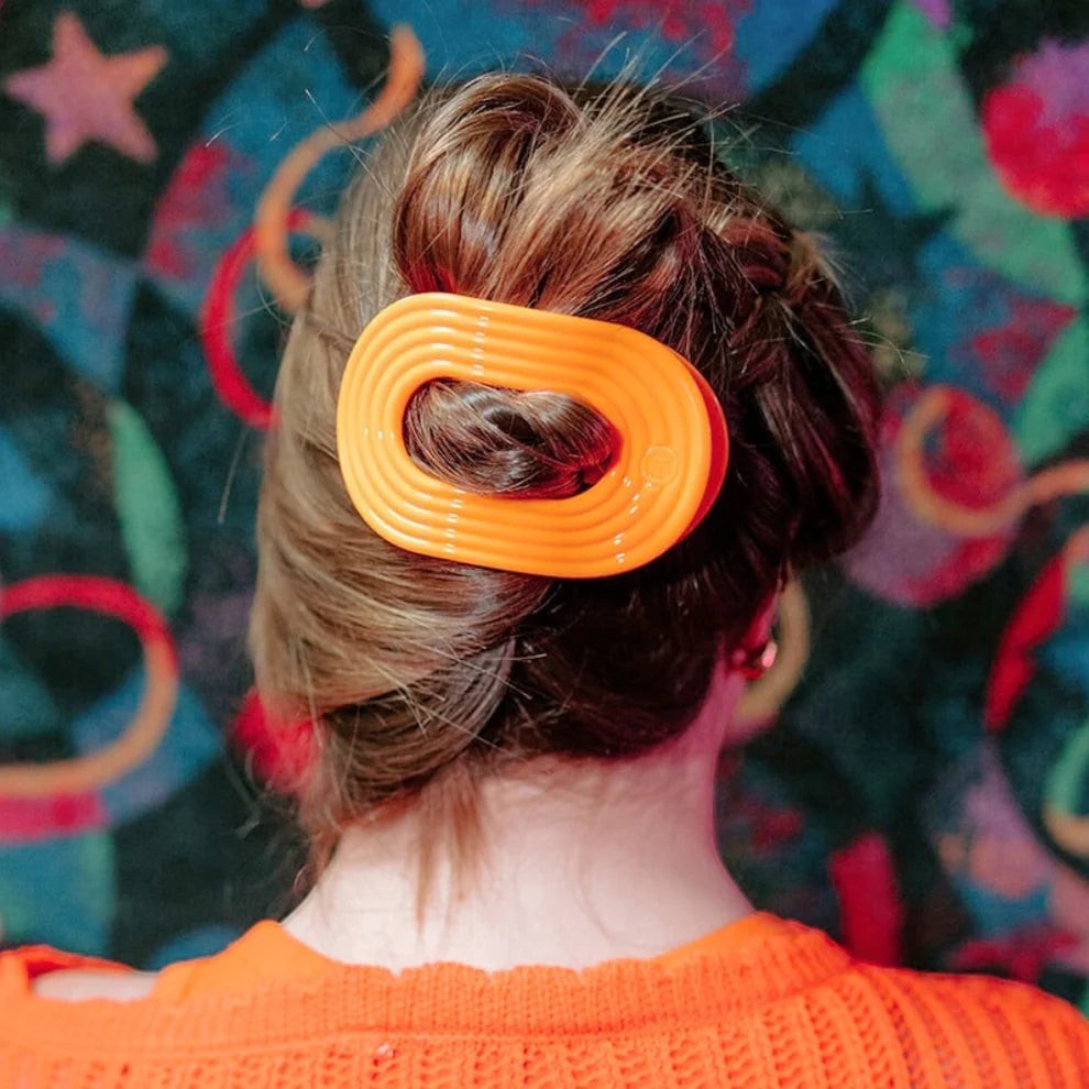 Doodlations Coffee Bar & Boutique Day Rave Flat Round Hair Clip in vibrant orange, perfect for updos and styling.