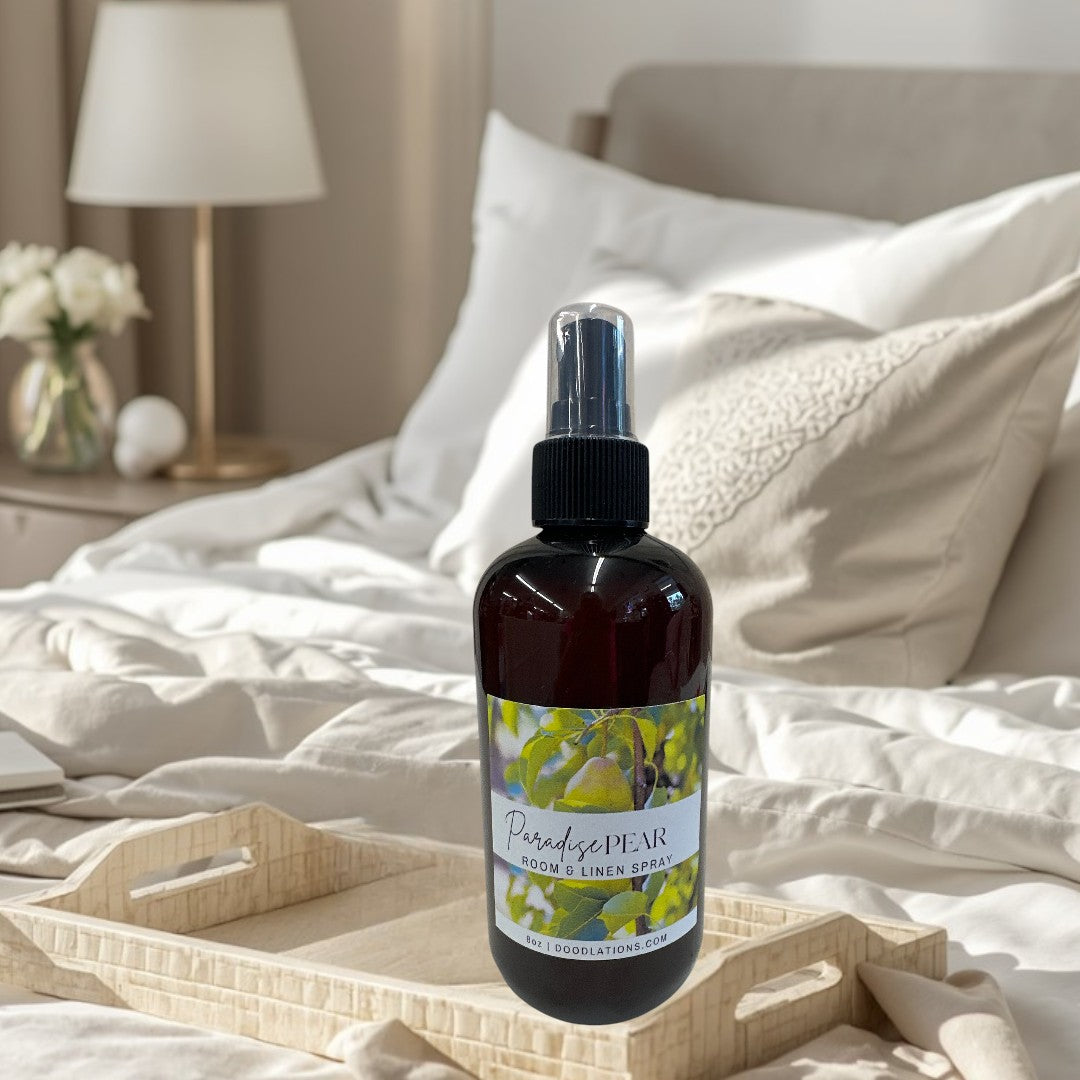 Doodlations Coffee Bar & Boutique Paradise Pear Room & Linen Spray in amber bottle with spray top. Features pear illustration.