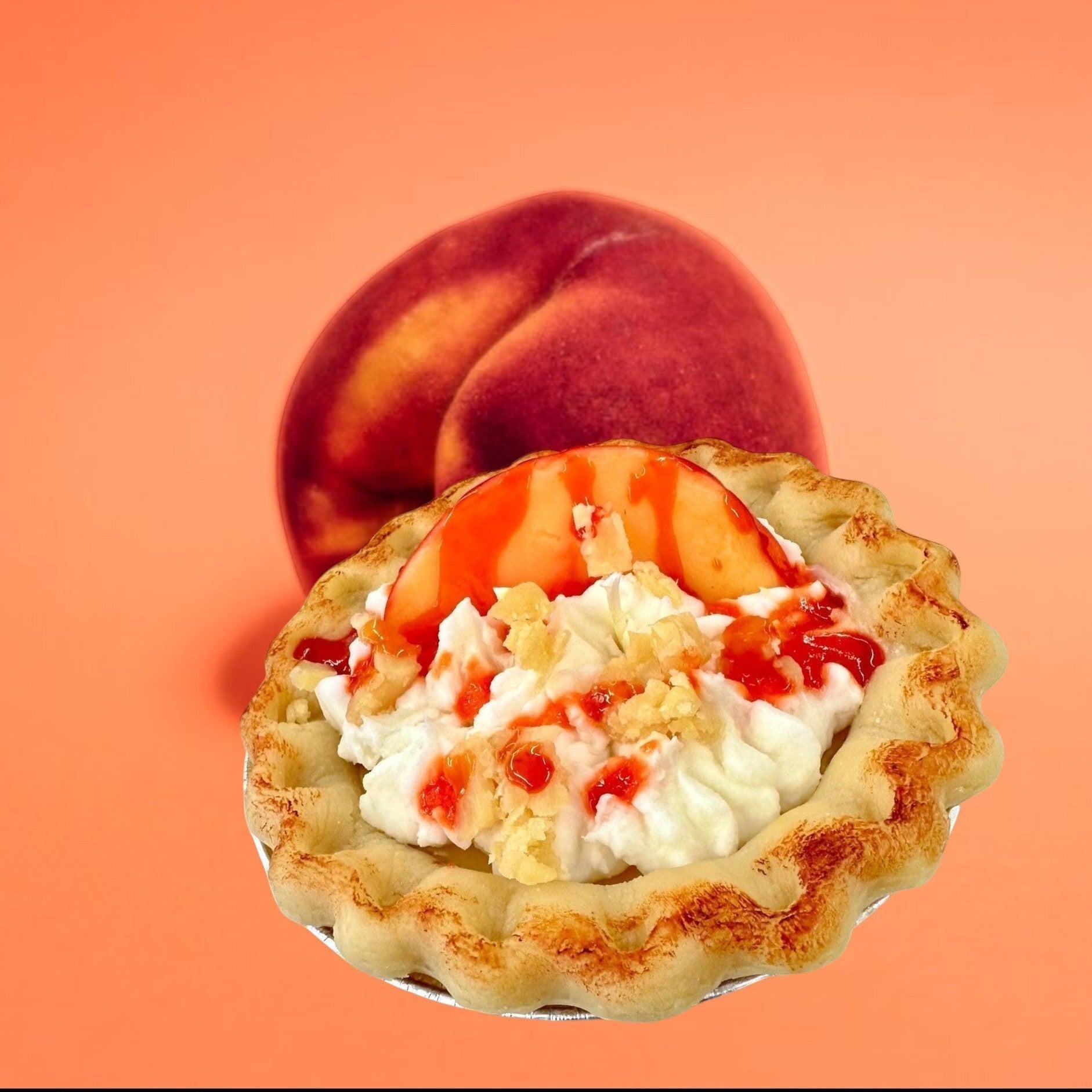Doodlations Coffee Bar & Boutique Peach Pie candle designed to look like a real pie with whipped cream, peach slices, and syrup.