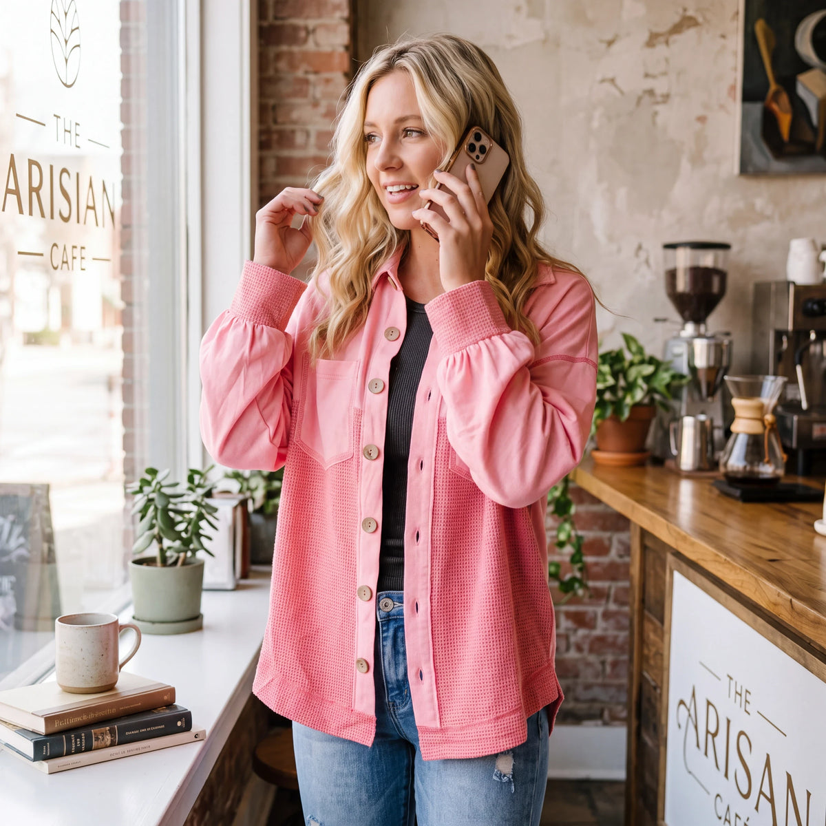 Doodlations Coffee Bar & Boutique peach blossom two-tone waffle knit shacket worn by a woman in a cafe