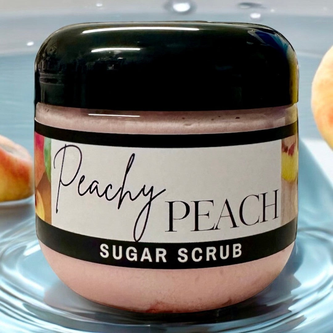 Doodlations Coffee Bar & Boutique Peachy Peach sugar scrub in a clear jar with a black lid. Pink scrub with peach imagery.