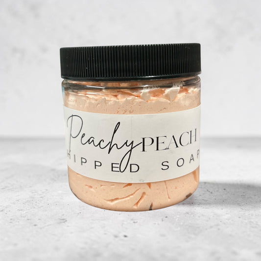 Doodlations Coffee Bar & Boutique Peachy Peach whipped soap in a 4 oz clear jar with a black lid.