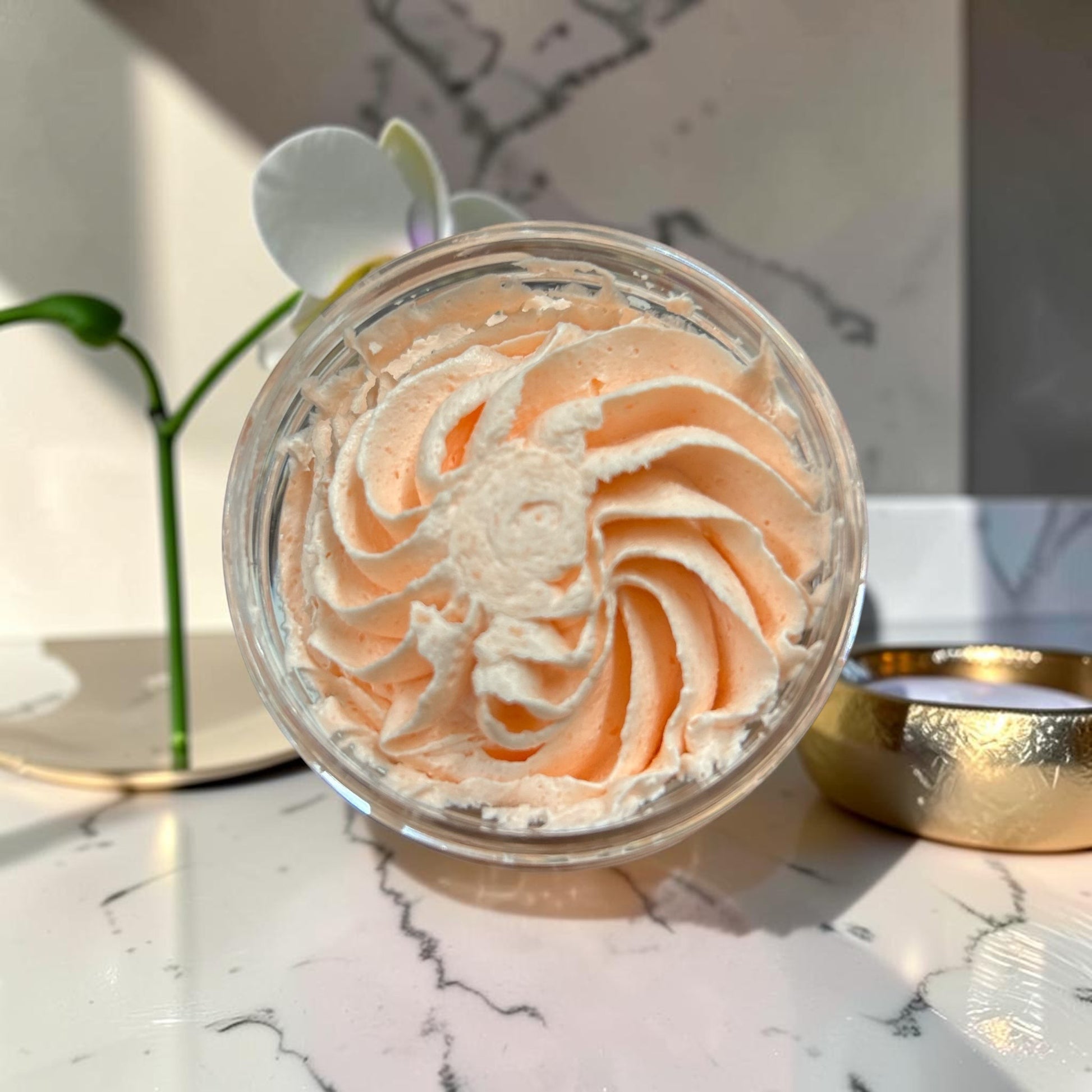 Doodlations Coffee Bar & Boutique whipped soap in a peach-colored swirl, nourishing body wash with grape seed oil.