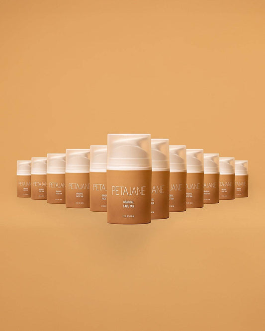 Doodlations Coffee Bar & Boutique Petajane Gradual Face Tan bottles arranged in a triangle on a tan background.
