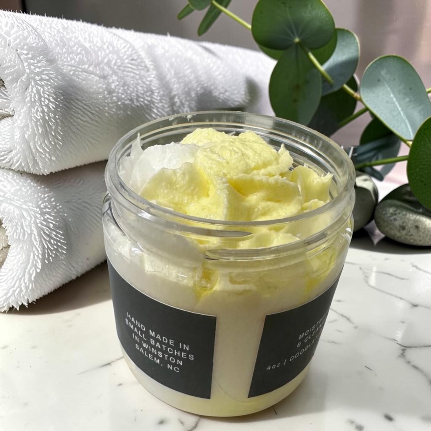 Doodlations Coffee Bar & Boutique pineapple mango whipped soap in a clear jar with a creamy yellow texture.