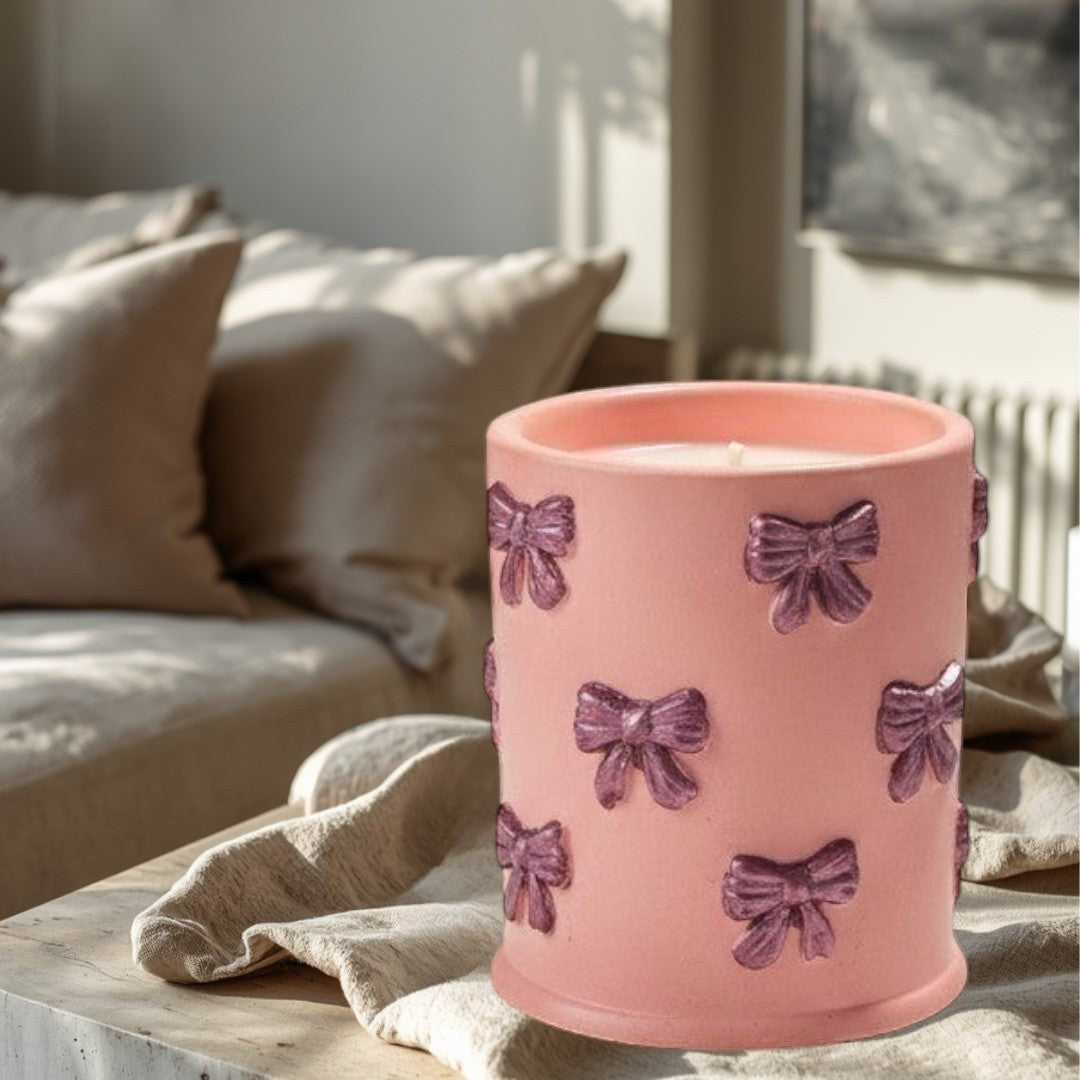 Doodlations Coffee Bar & Boutique pink concrete candle with bow details, soy blend wax, Tipsy Berry Cherry scent.