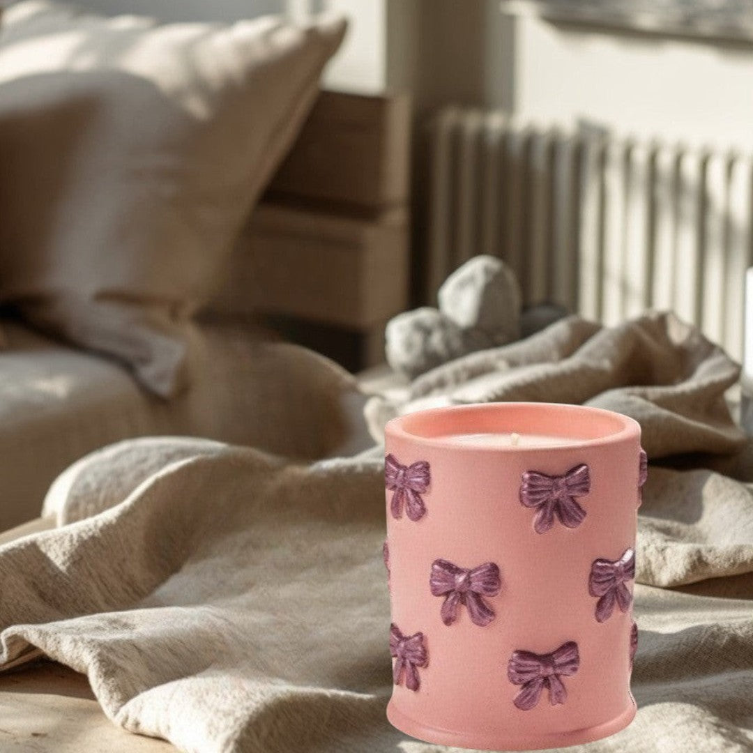 Doodlations Coffee Bar & Boutique pink concrete candle with bow details, soy blend wax, Tipsy Berry Cherry scent.