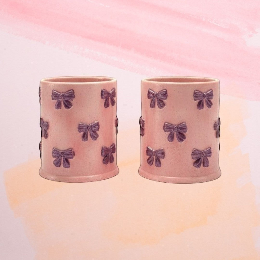 Doodlations Coffee Bar & Boutique pink concrete candle with purple bow embellishments, soy blend wax, 8oz