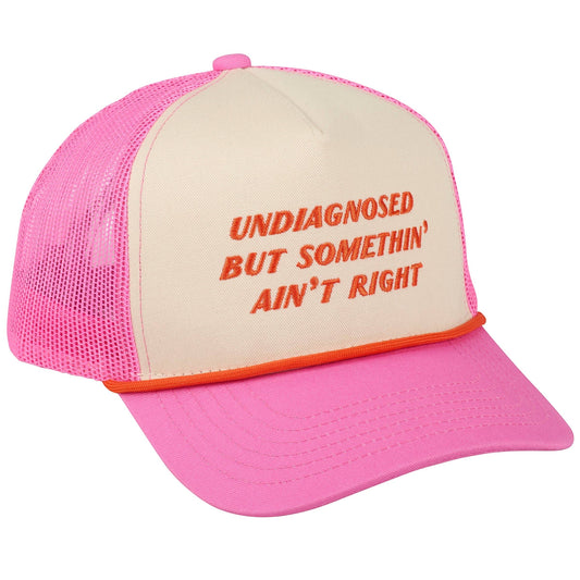Doodlations Coffee Bar & Boutique cream trucker hat with pink mesh sides, brim, and embroidered orange text.