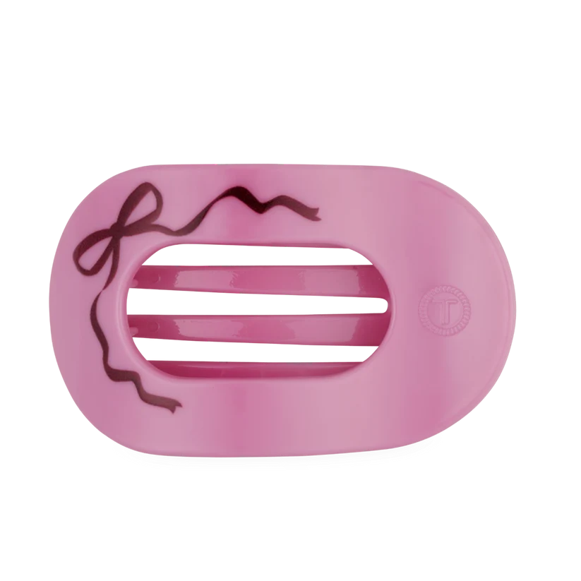 Doodlations Coffee Bar & Boutique pink Teleties flat round hair clip with a decorative bow design for comfortable wear.