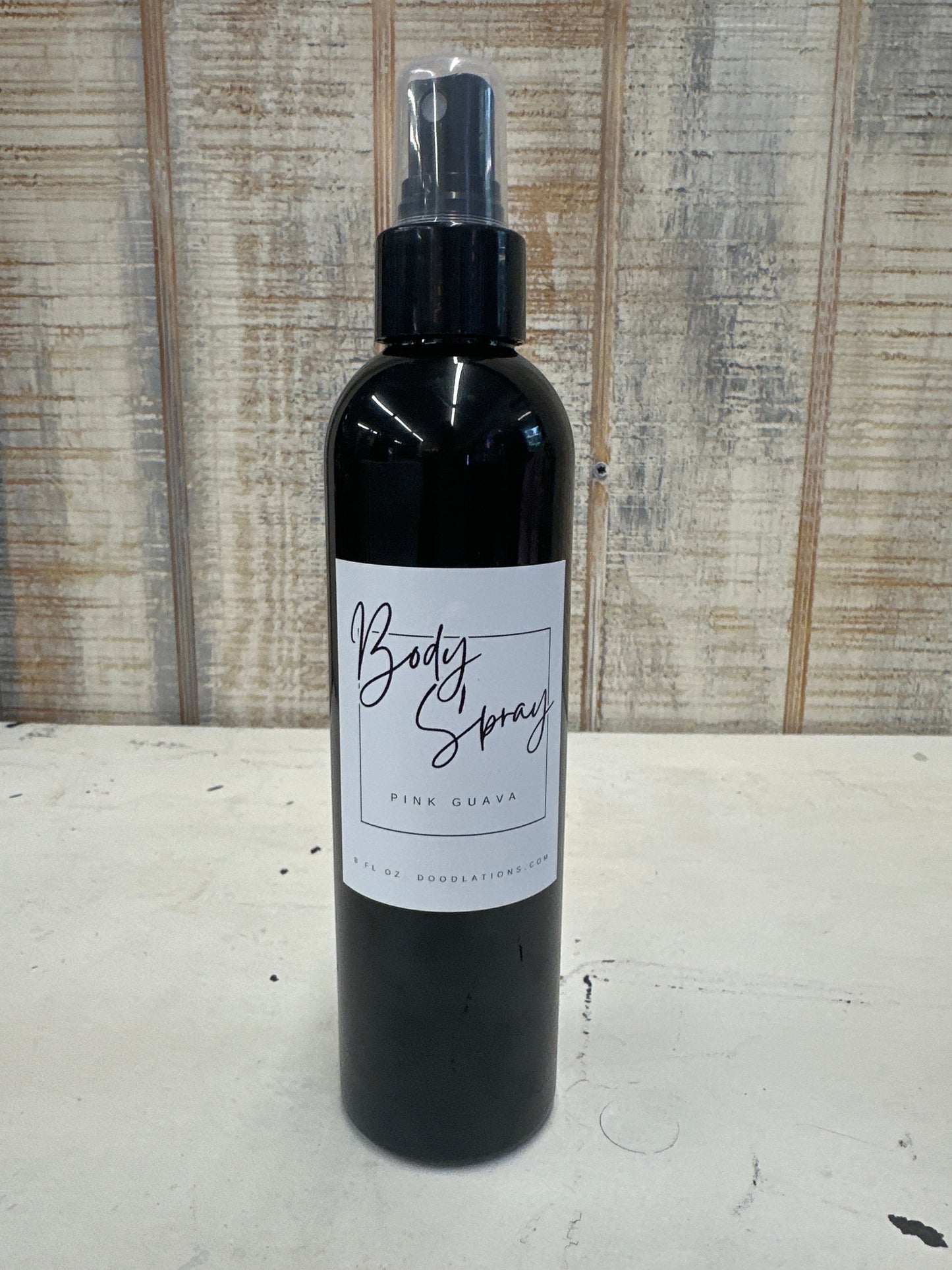 Doodlations Coffee Bar & Boutique 8oz Pink Guava moisturizing body spray in a black bottle with a spray nozzle.