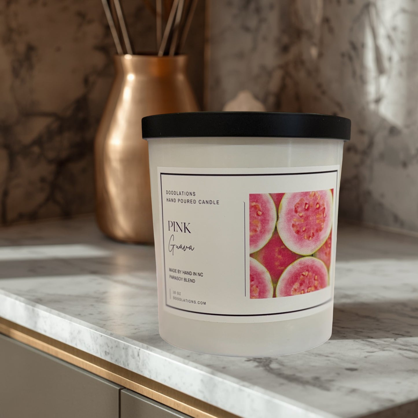 Doodlations Coffee Bar & Boutique Pink Guava hand-poured parasoy blend candle with a tropical beach background.