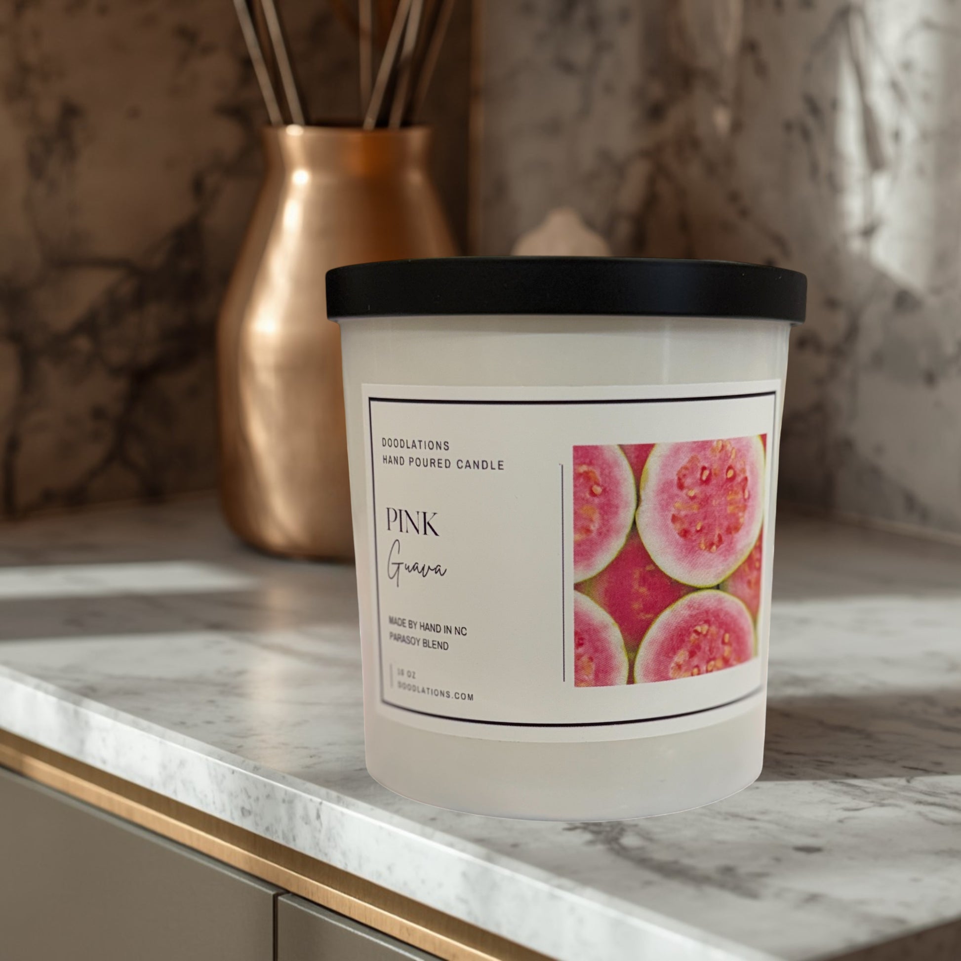 Doodlations Coffee Bar & Boutique Pink Guava hand-poured parasoy blend candle with a tropical beach background.
