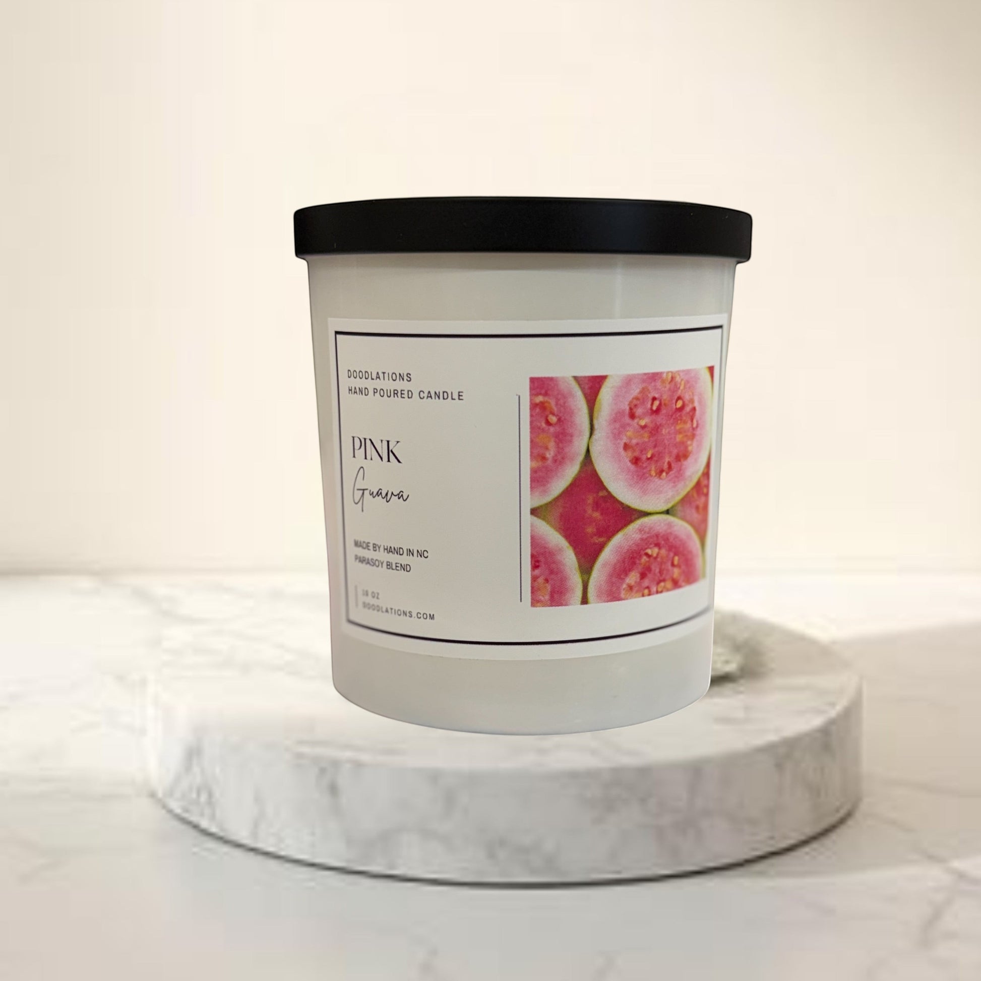 Doodlations Coffee Bar & Boutique Pink Guava hand-poured parasoy blend candle with tropical beach background.