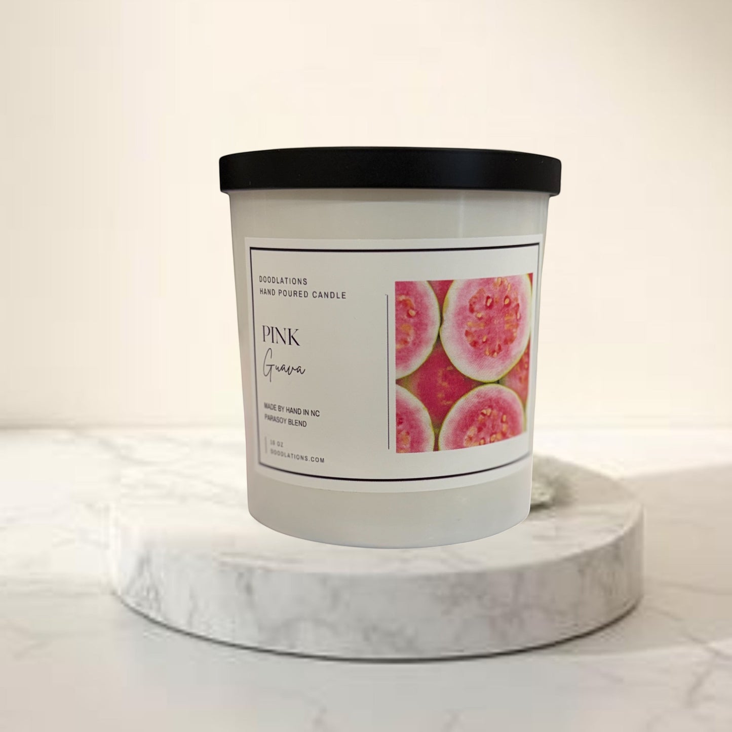 Doodlations Coffee Bar & Boutique Pink Guava hand-poured parasoy blend candle with tropical beach background.