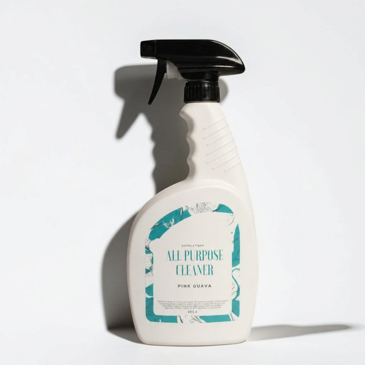 Doodlations Coffee Bar & Boutique Pink Guava all purpose cleaning spray in a white bottle with a black trigger sprayer.