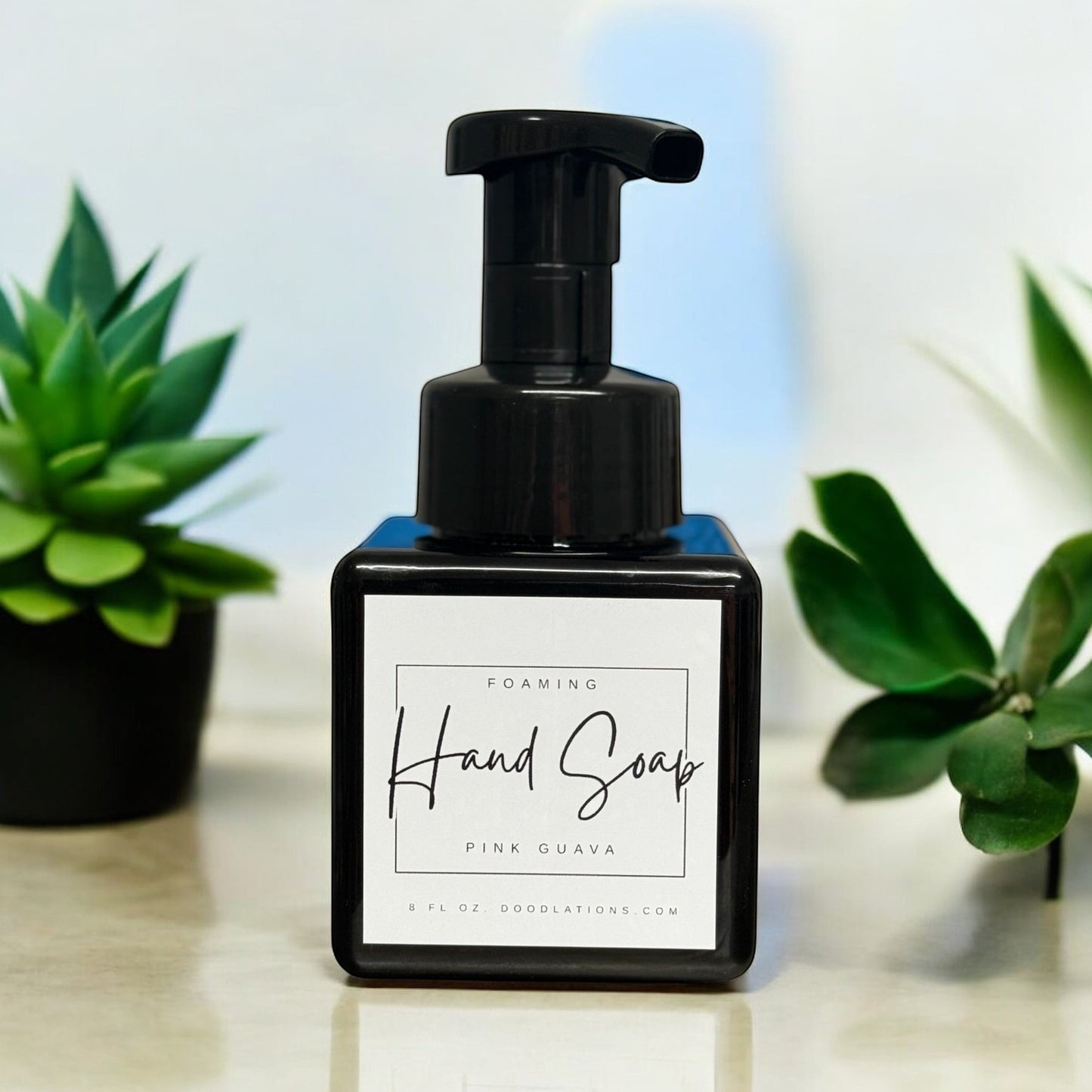 Doodlations Coffee Bar & Boutique Pink Guava Foaming Hand Soap in a black square bottle with a black pump dispenser.