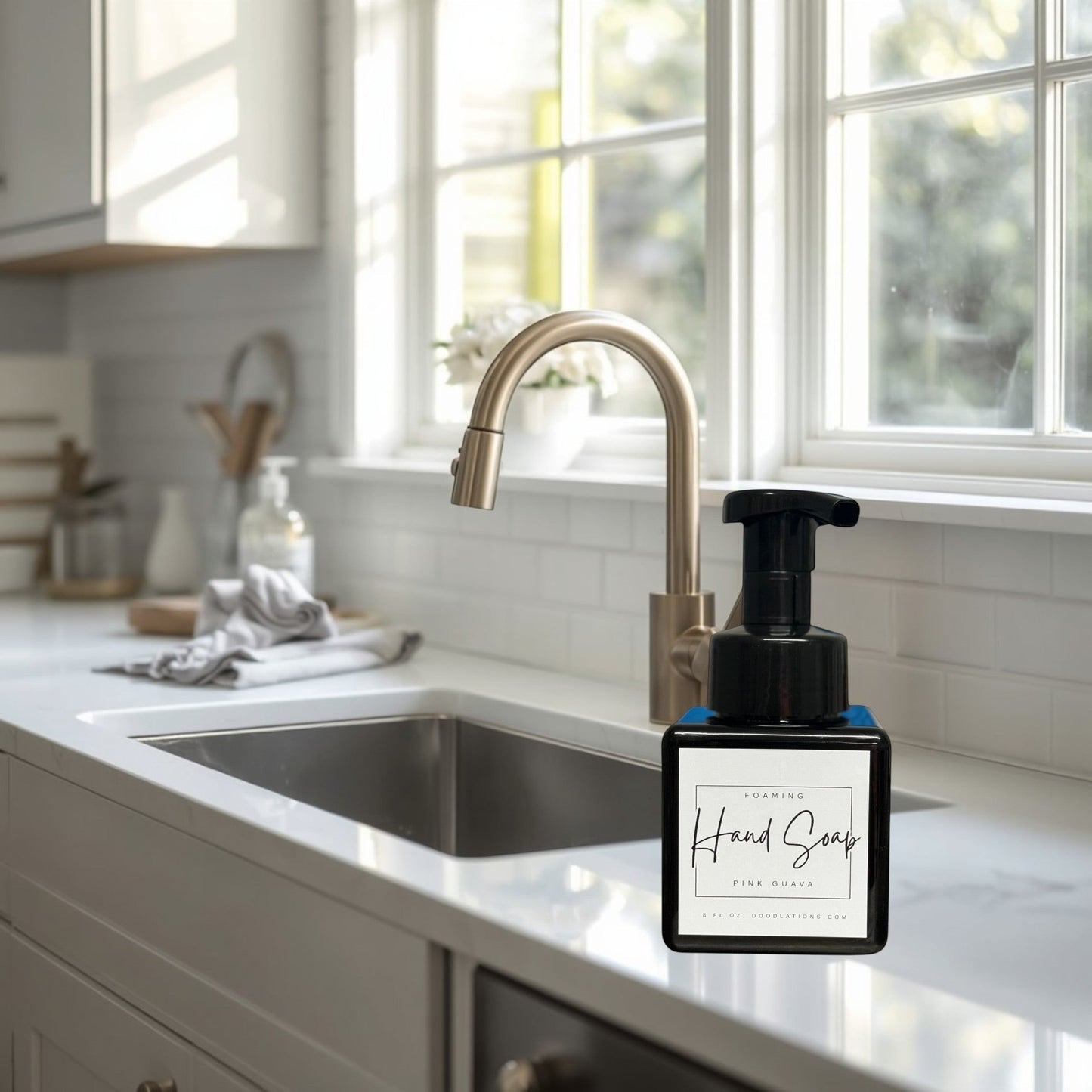 Doodlations Coffee Bar & Boutique Pink Guava foaming hand soap in a black pump bottle with a white label.