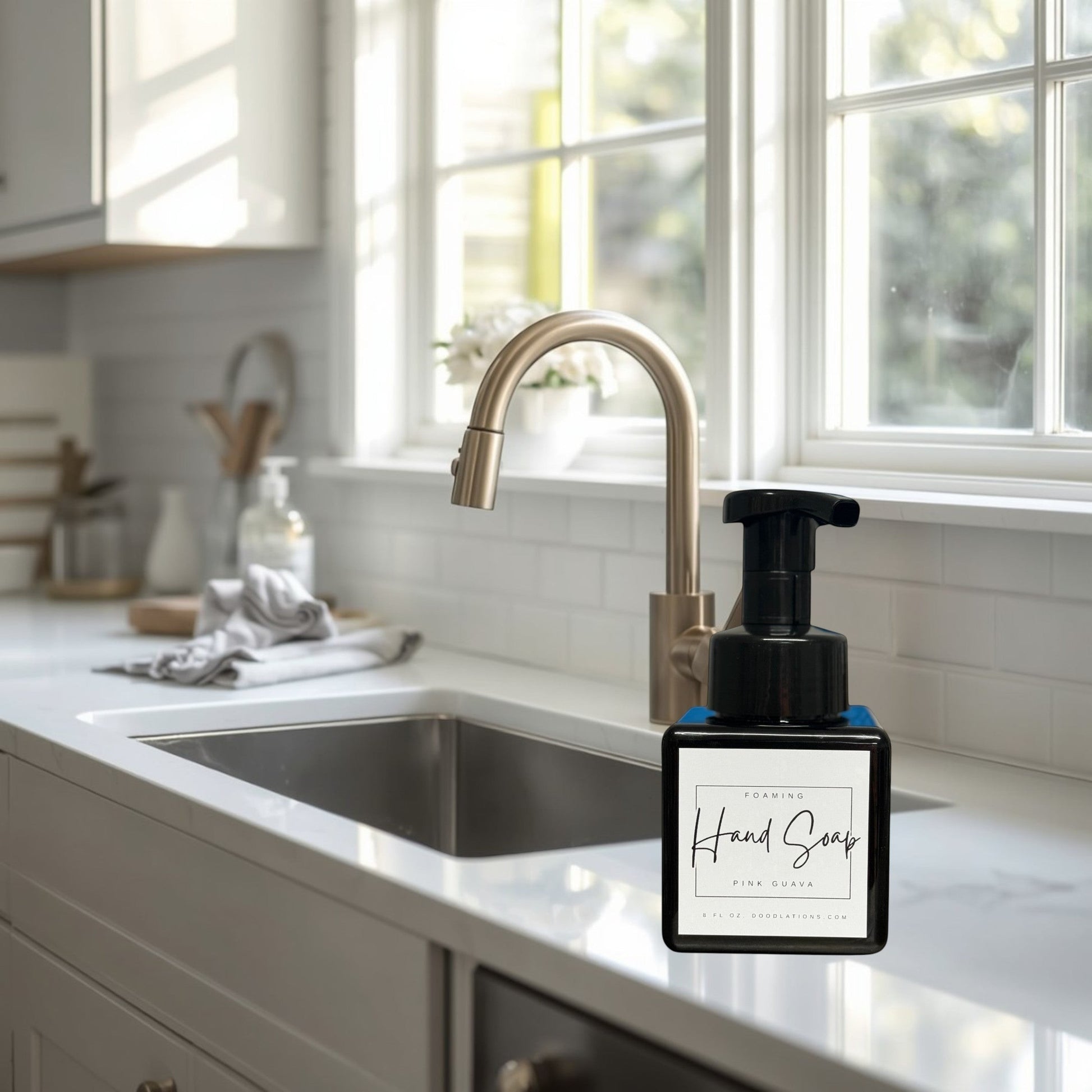 Doodlations Coffee Bar & Boutique Pink Guava foaming hand soap in a black pump bottle with a white label.