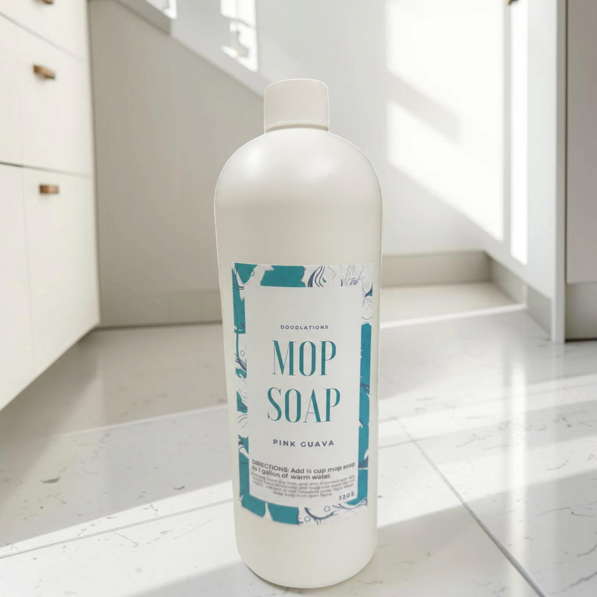 Doodlations Coffee Bar & Boutique 32 oz concentrated pink guava mop soap bottle on a clean white tiled floor.