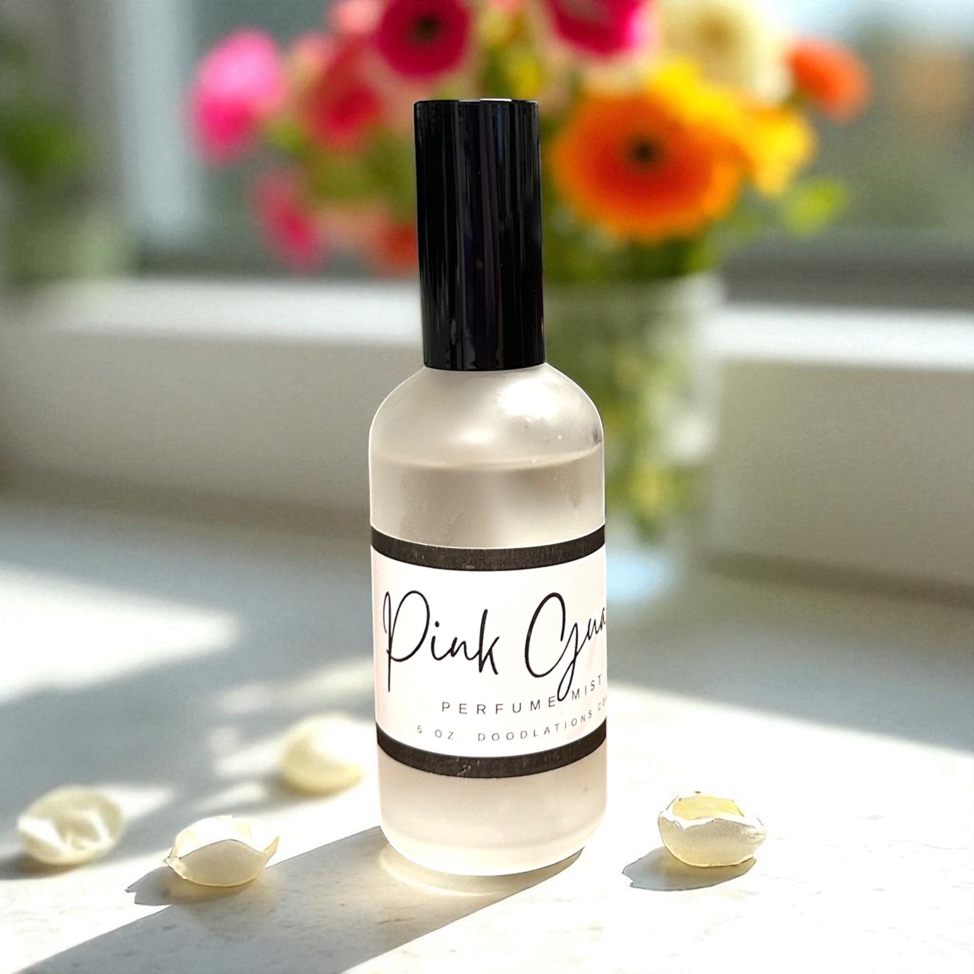 Doodlations Coffee Bar & Boutique Pink Guava fine mist perfume in a frosted glass bottle with a black cap.