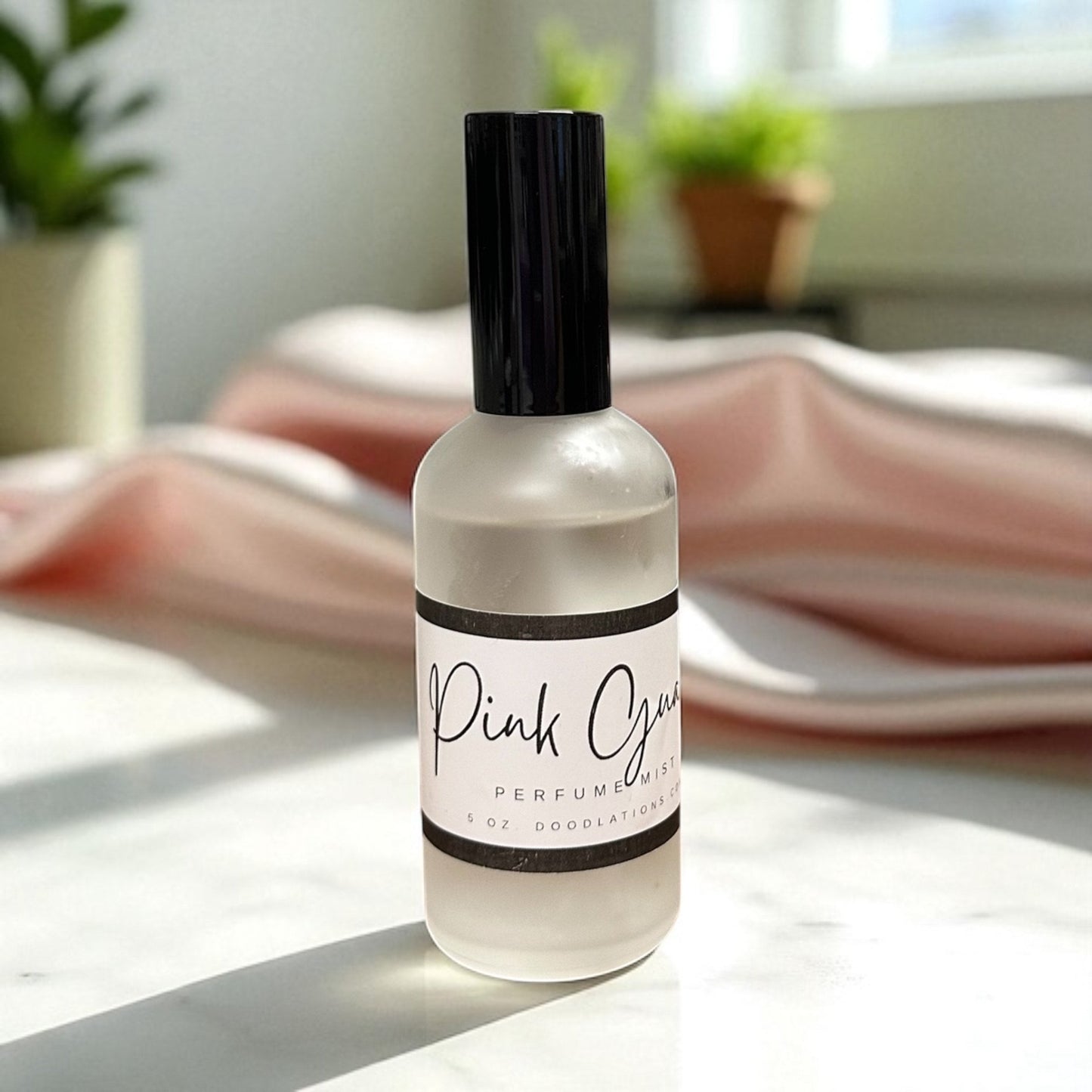 Doodlations Coffee Bar & Boutique Pink Guava fine mist perfume in a sleek frosted glass bottle on a white surface.