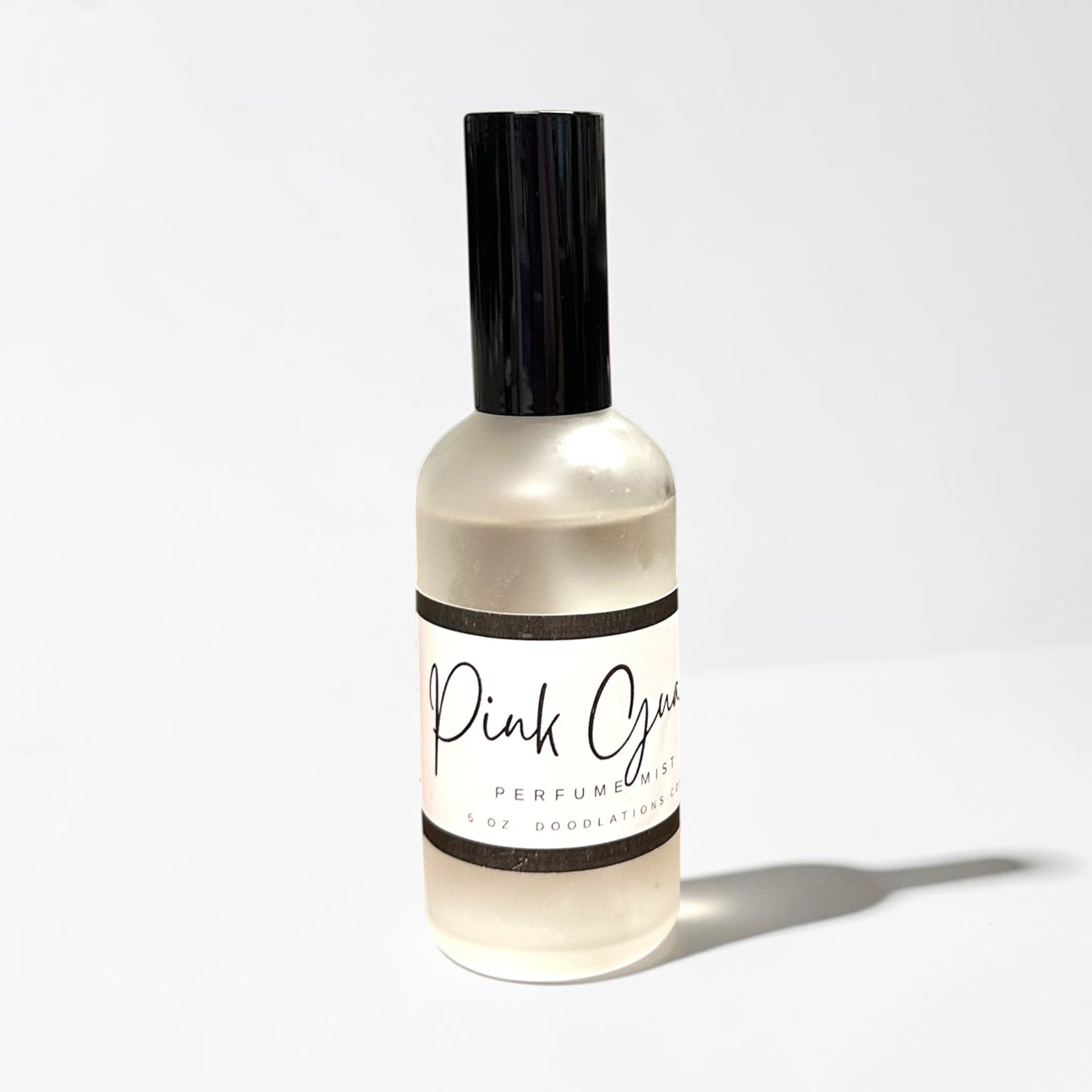 Doodlations Coffee Bar & Boutique Pink Guava fine mist perfume in a sleek 5oz glass bottle with a black cap.