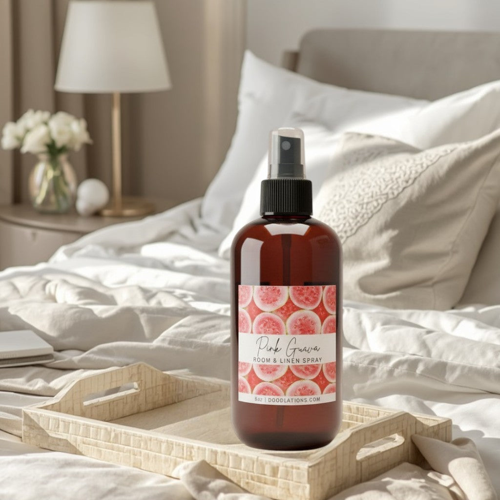 Doodlations Coffee Bar & Boutique Pink Guava room and linen spray in amber bottle with guava slice label.