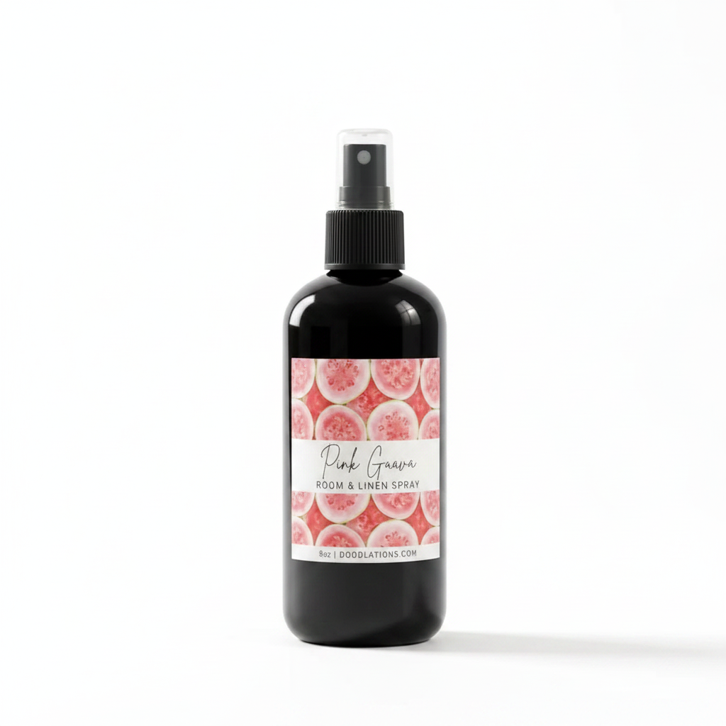 Doodlations Coffee Bar & Boutique Pink Guava room and linen spray in a black bottle with a tropical fruit label.
