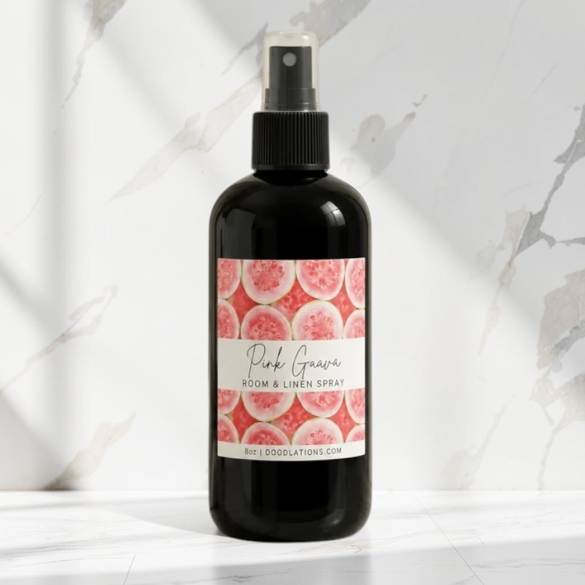 Doodlations Coffee Bar & Boutique Pink Guava room and linen spray in a black bottle with a tropical fruit label