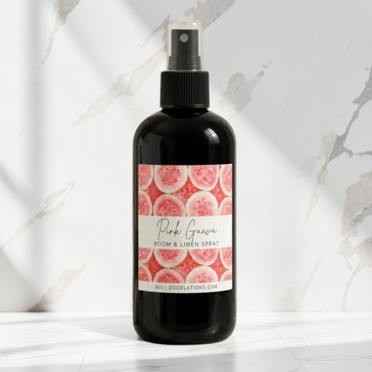 Doodlations Coffee Bar & Boutique Pink Guava room and linen spray in a black bottle with a tropical fruit label