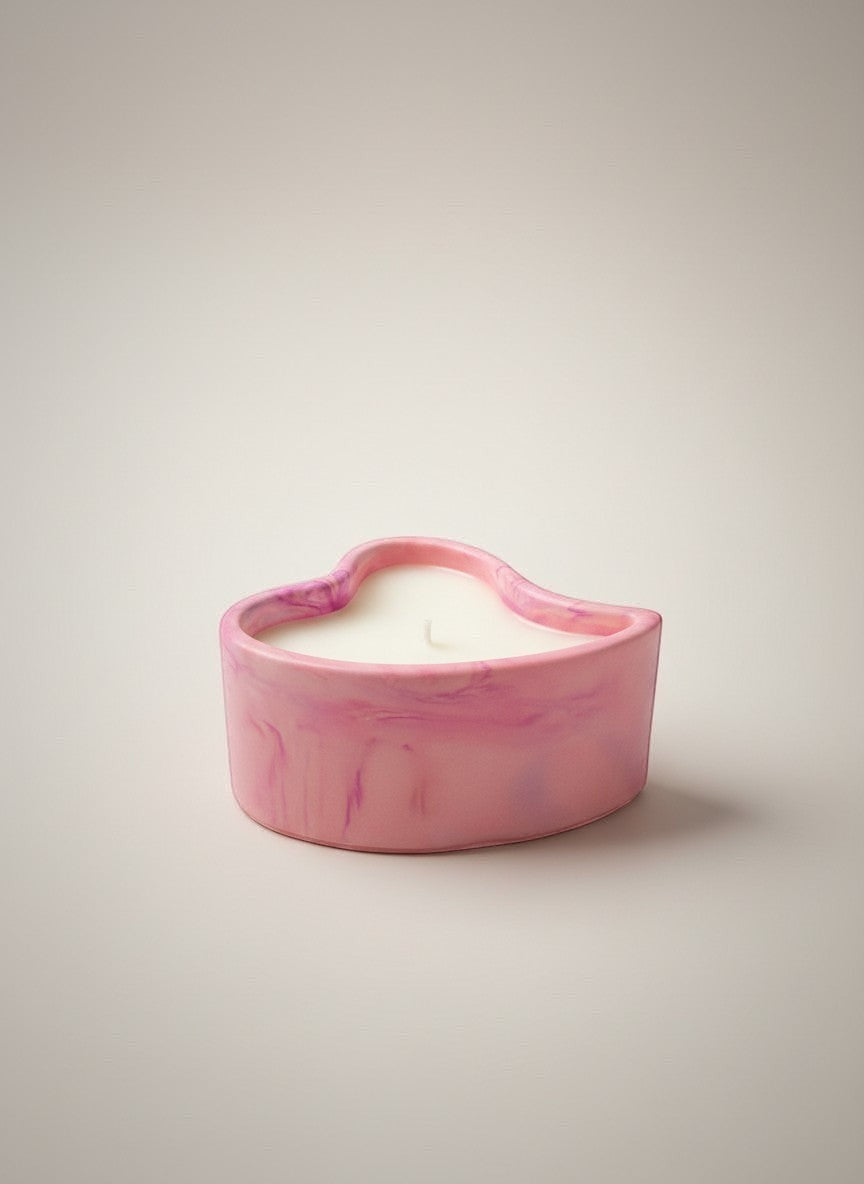 Doodlations Coffee Bar & Boutique pink marbled concrete heart-shaped candle with white wax.