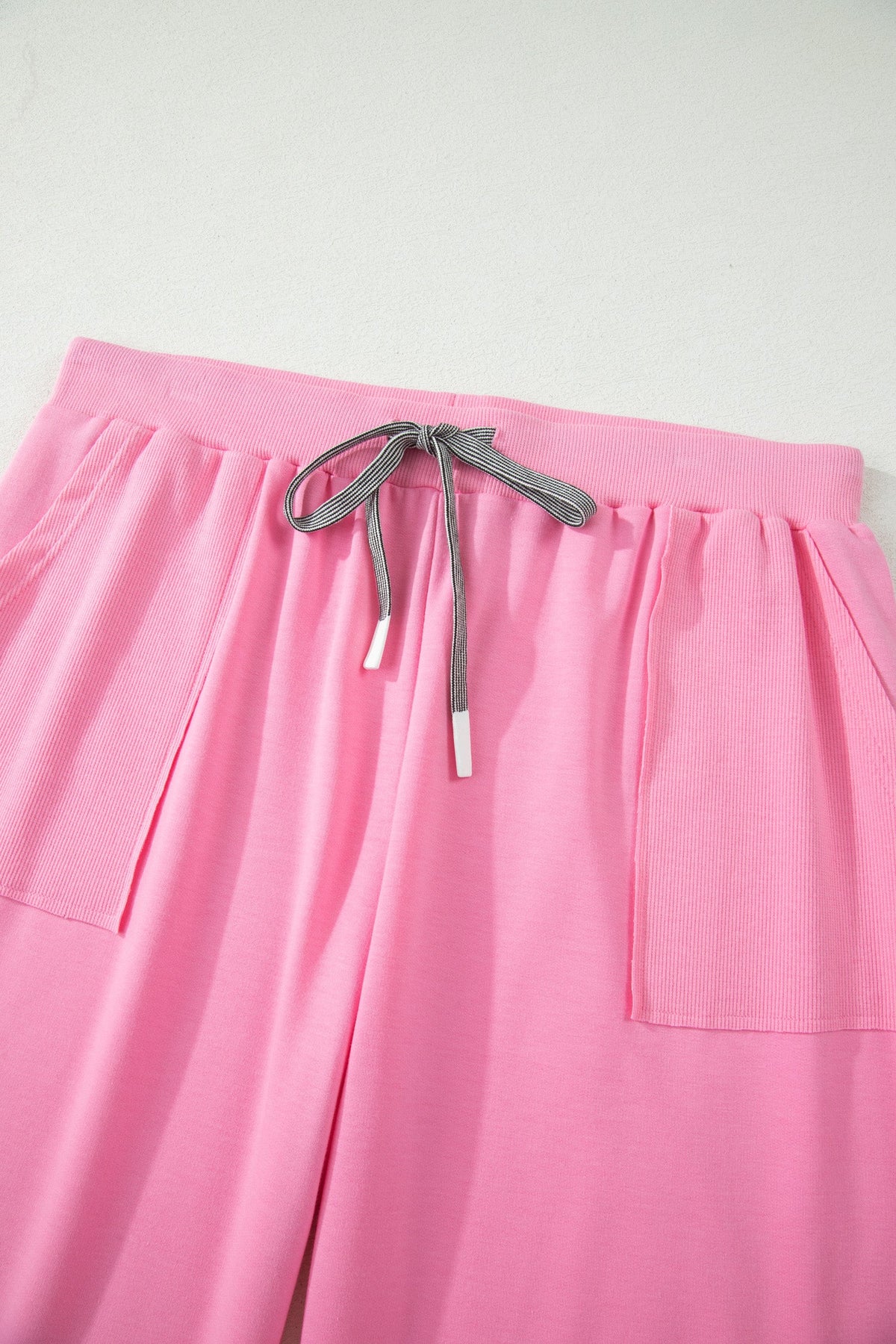 Doodlations Coffee Bar & Boutique pink lounge pants with elastic waistband, drawstring tie, and side pockets.
