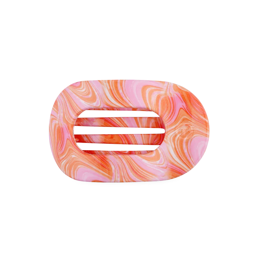 Doodlations Coffee Bar & Boutique Just Keep Swimming flat round hair clip in a pink and orange marble swirl pattern
