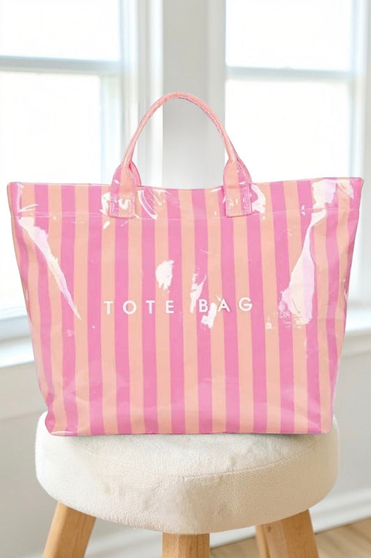 Doodlations Coffee Bar & Boutique pink and orange striped glossy PVC tote bag with white text on a wooden stool.
