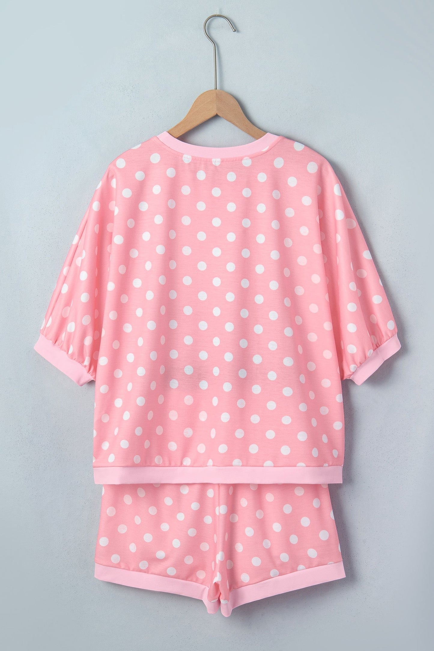 Doodlations Coffee Bar & Boutique pink lounge set with white polka dots, featuring a short-sleeve top and shorts.