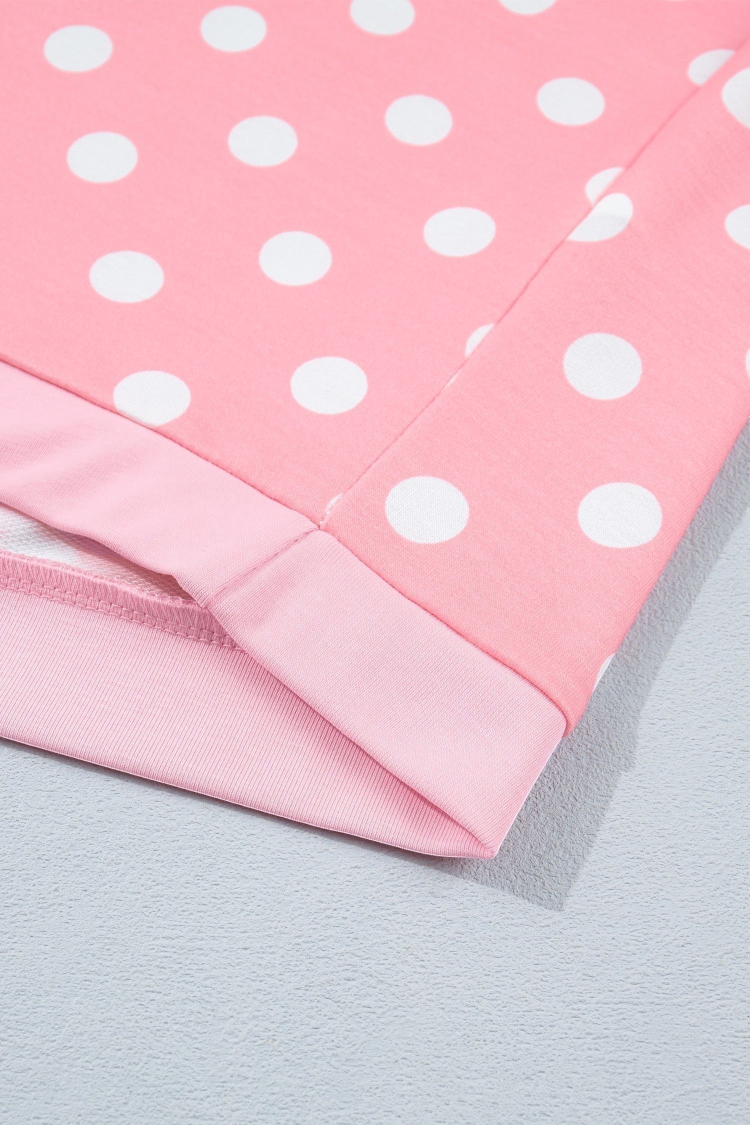 Doodlations Coffee Bar & Boutique pink lounge set featuring a white polka dot pattern and soft ribbed hem detail.