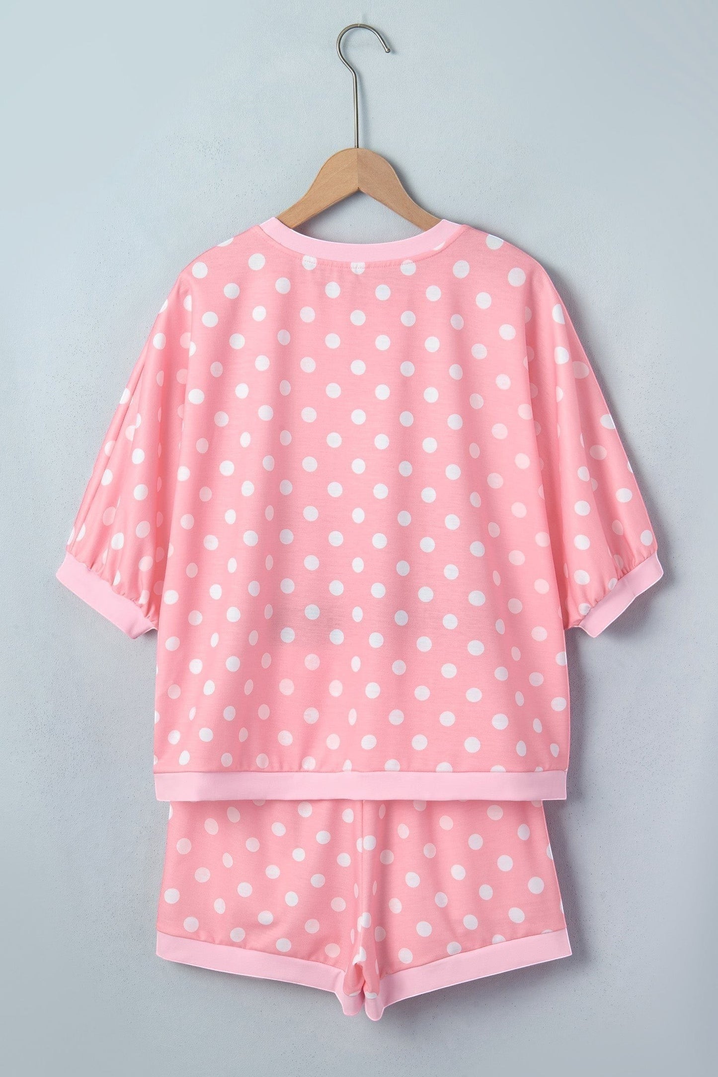 Doodlations Coffee Bar & Boutique pink polka dot lounge set with short sleeves and shorts on a hanger