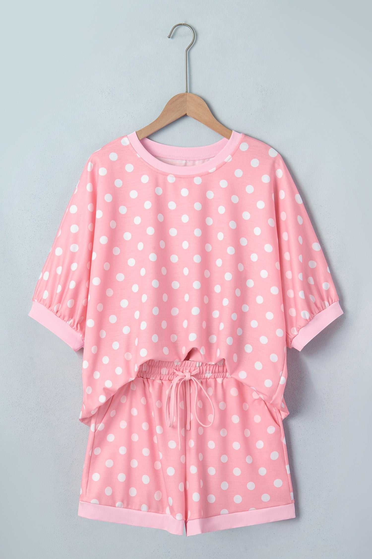 Doodlations Coffee Bar & Boutique pink and white polka dot lounge set with short sleeves and drawstring shorts.