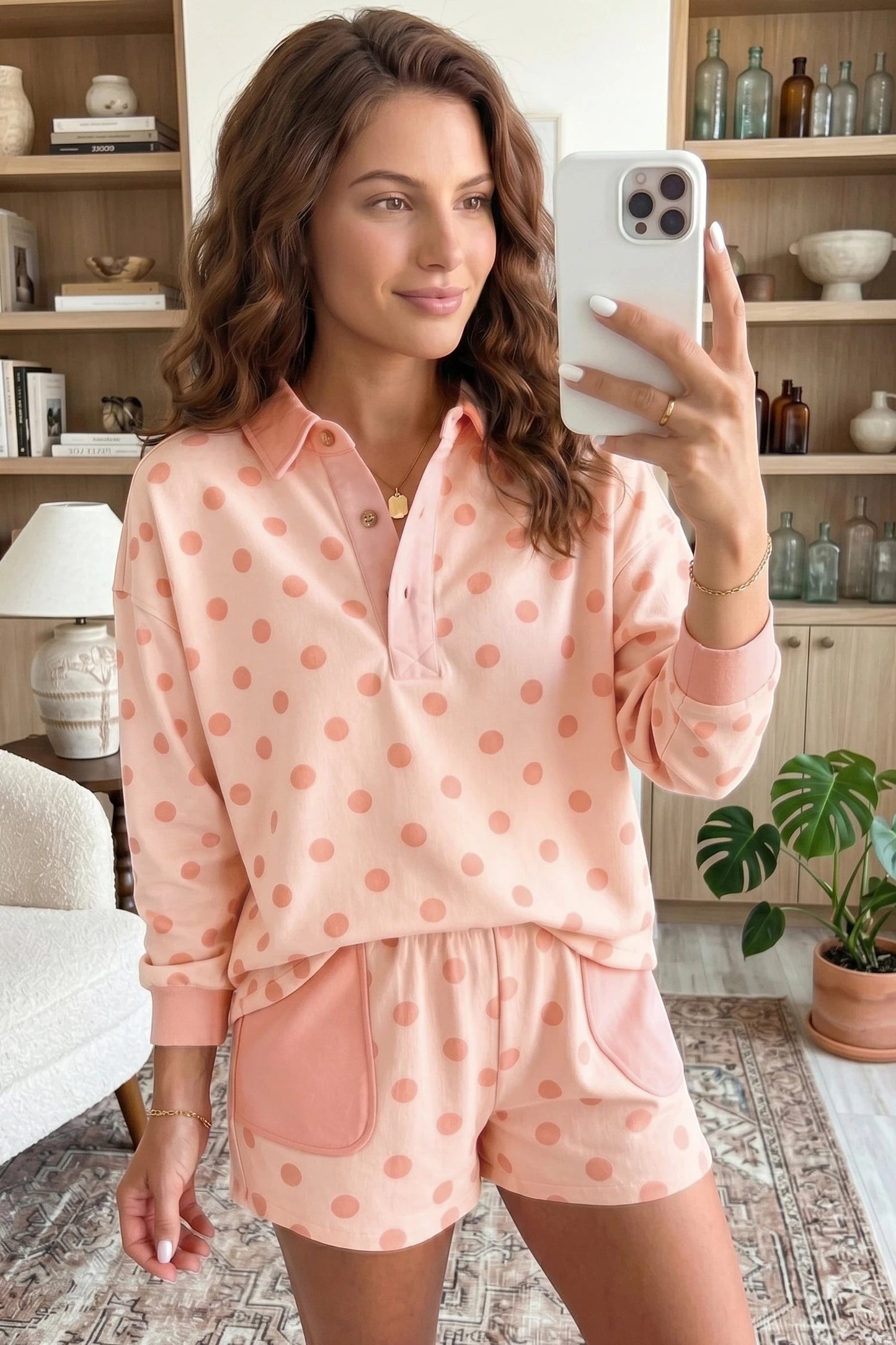 Doodlations Coffee Bar & Boutique pink polka dot drop shoulder polo pullover and matching shorts set on a woman