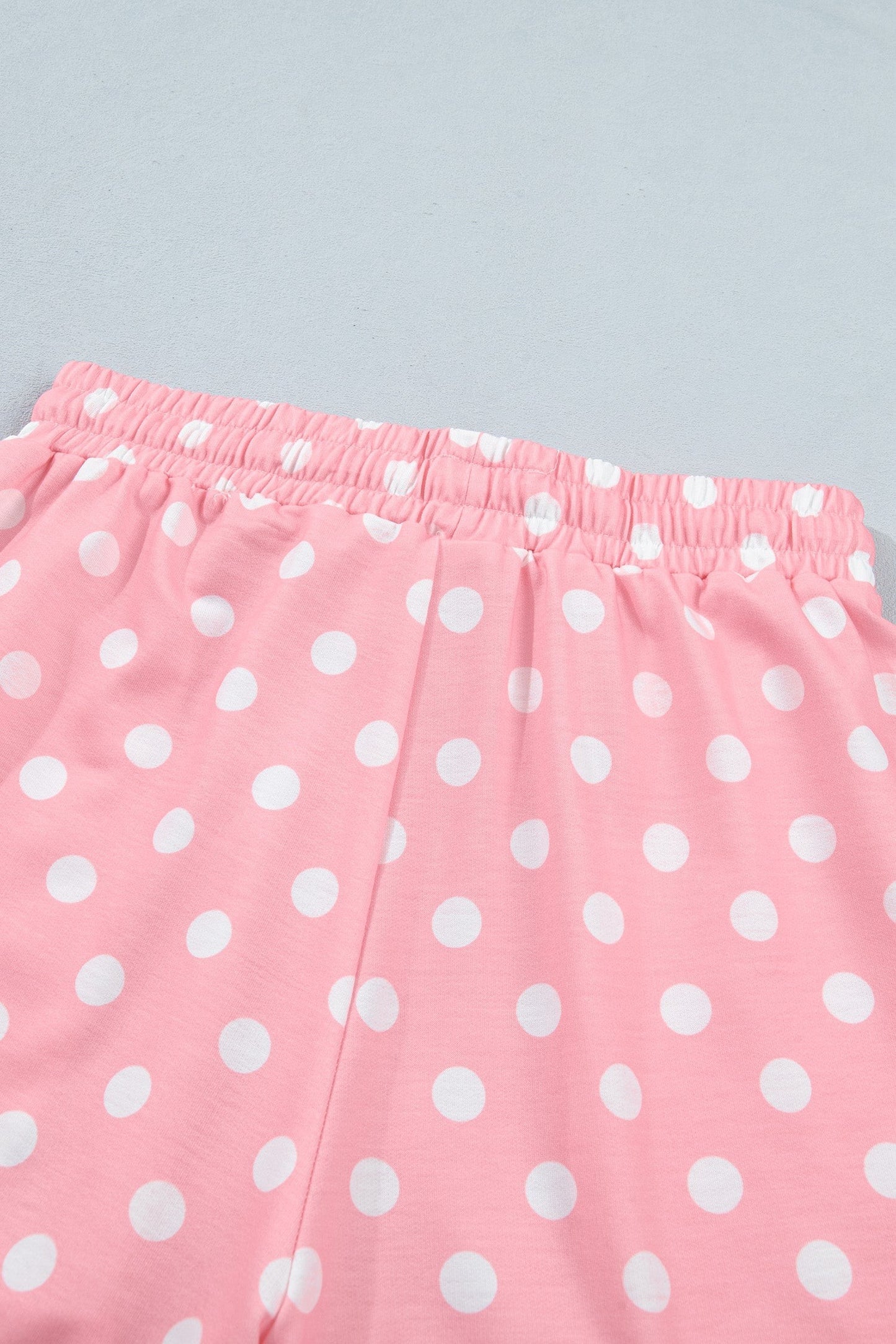 Doodlations Coffee Bar & Boutique pink lounge shorts with white polka dots and an elastic drawstring waistband.