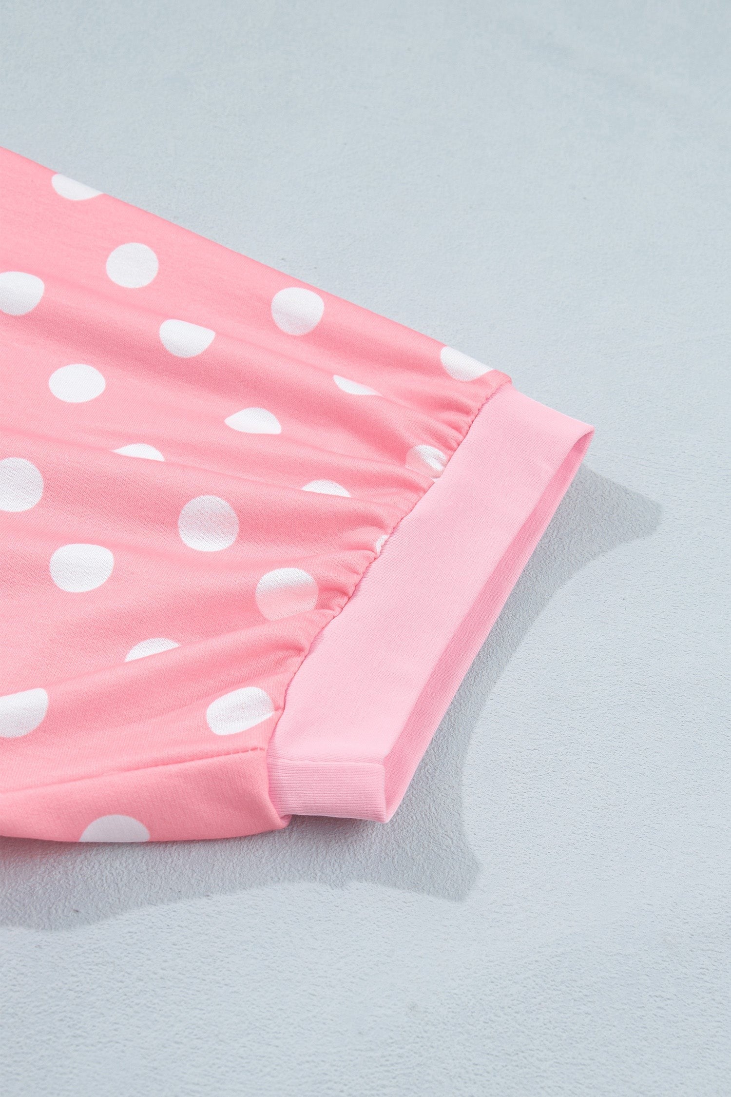 Doodlations Coffee Bar & Boutique pink lounge set sleeve with white polka dots and a soft cuffed hem detail