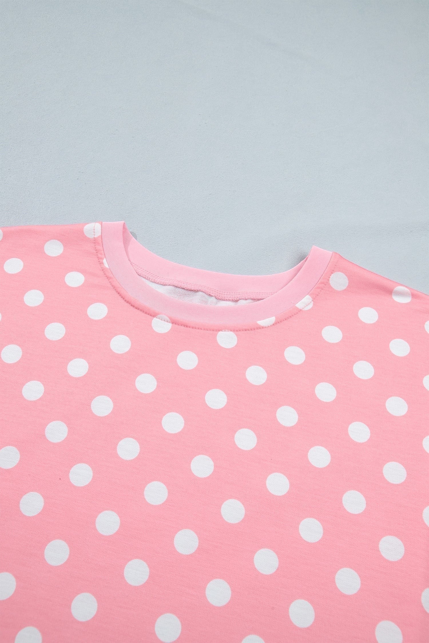 Doodlations Coffee Bar & Boutique pink lounge top with white polka dots and a crew neckline