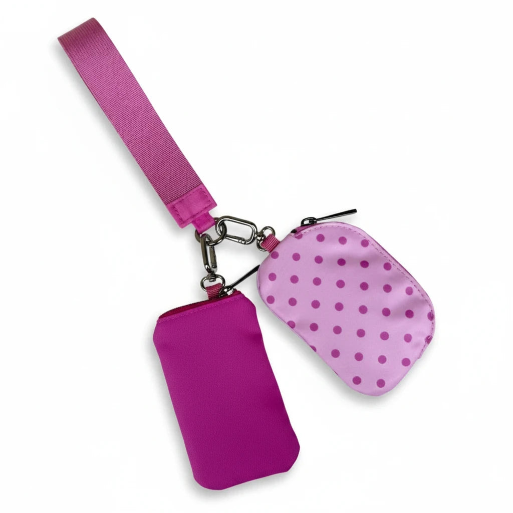 Doodlations Coffee Bar & Boutique Lulu Mac double pouch wristlet in pink and hot pink with a polka dot pattern.