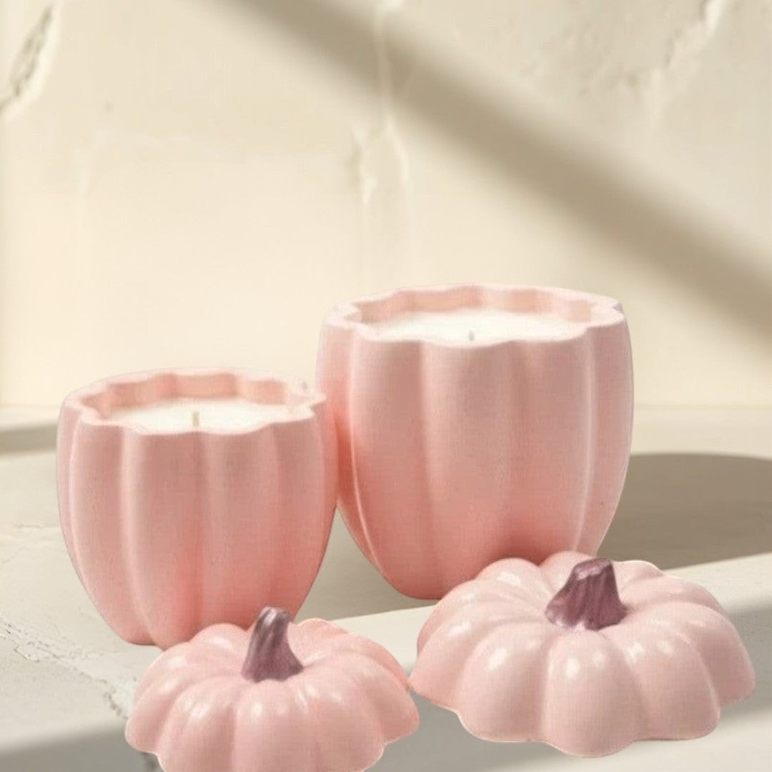 Doodlations Coffee Bar & Boutique pink concrete pumpkin candles in two sizes with removable lids.